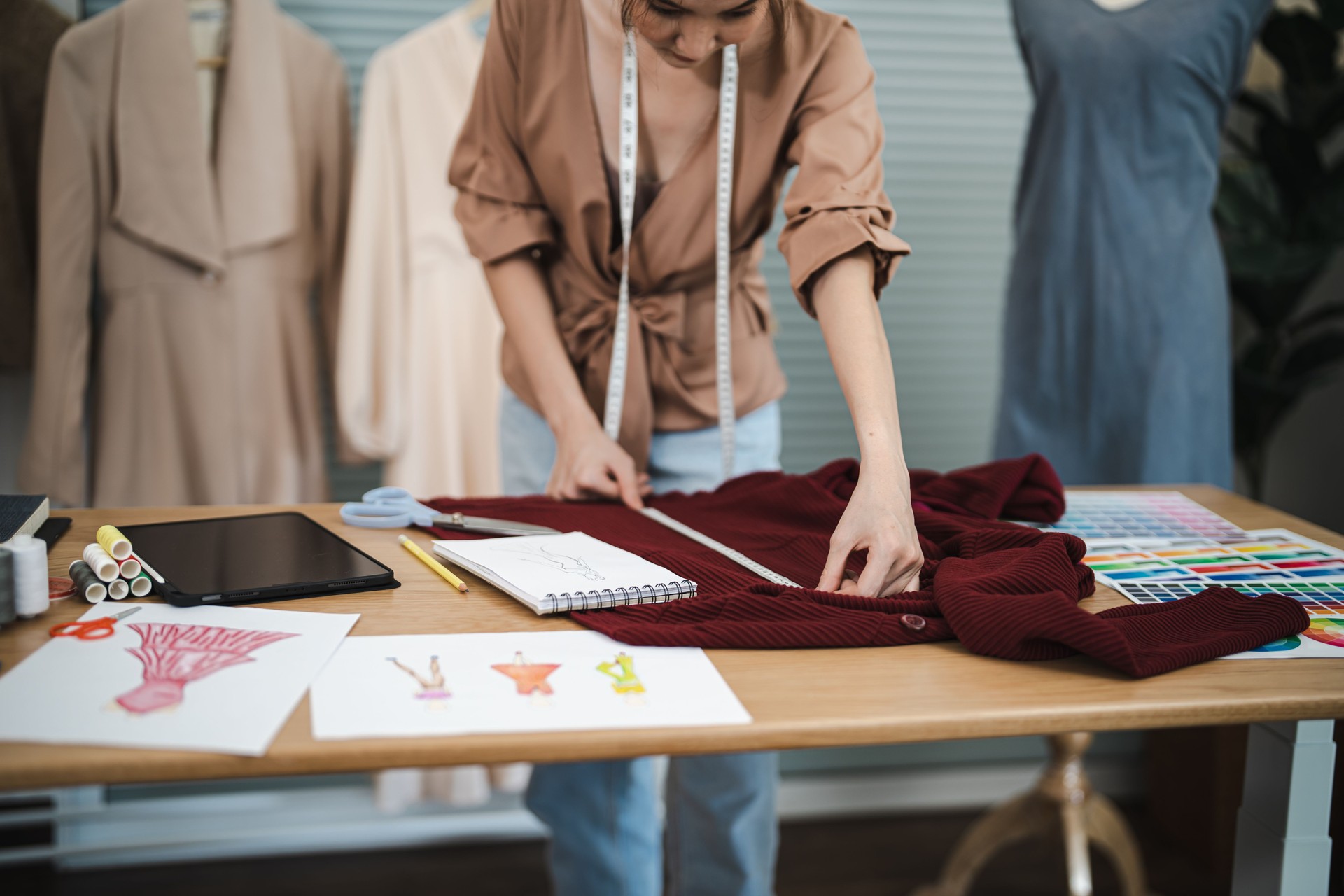 Tailor woman working in tailor shop Stylish Fashion designer tailor in workshop studio designing new collection Dressmaking and Creative
fashion collection.
